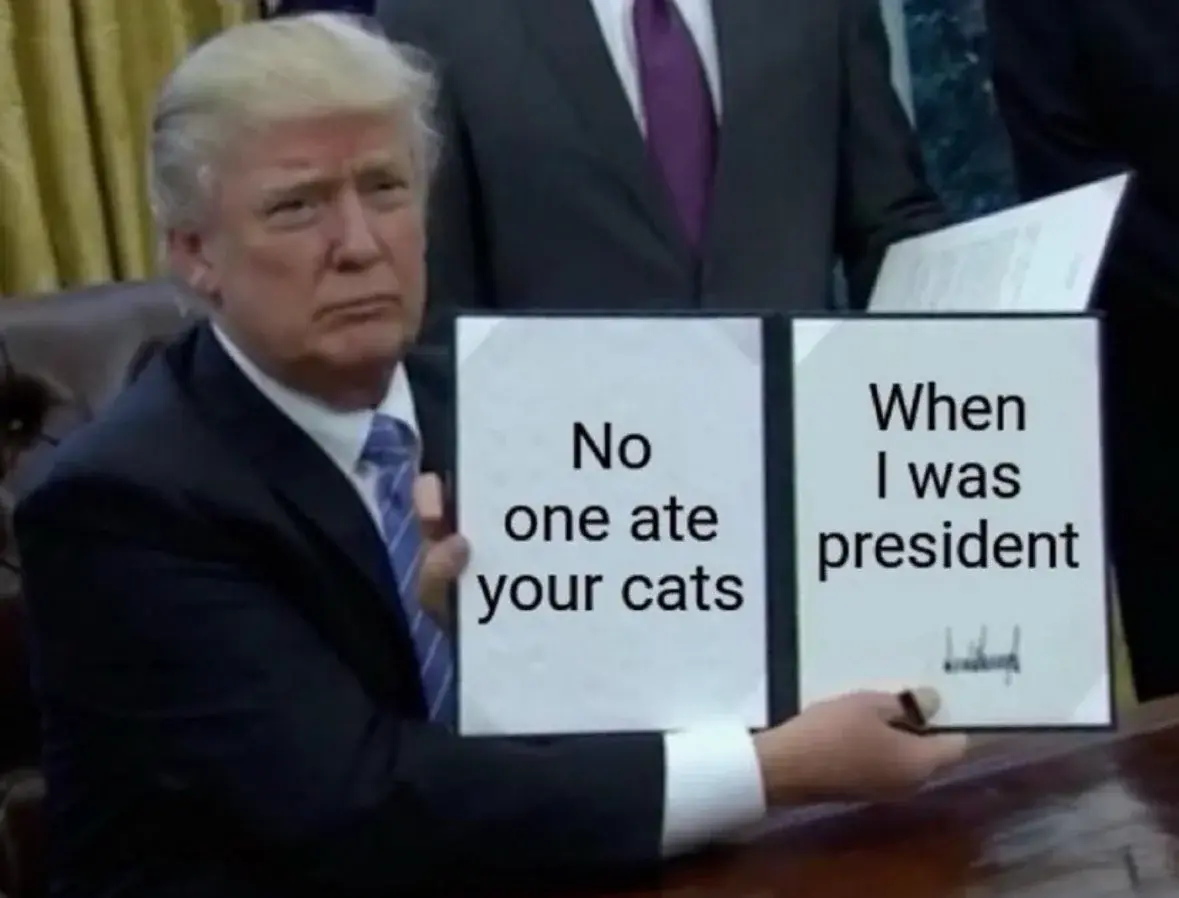 Photo: Donald Trump holding a bill page that states: "No one ate your cats when I was President"