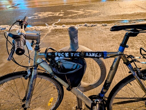 A bicycle with a sticker saying "fuck the banks"